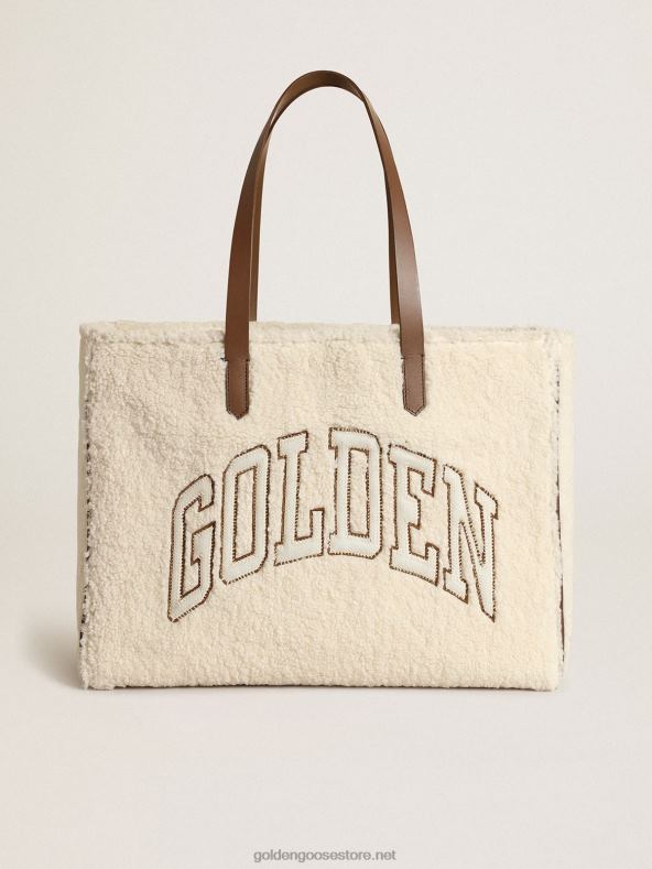 naised ida-lääne suunaline valgest kunstkarusnahast kott kuldse kirja ja kontrastsete sangadega B6B0T446